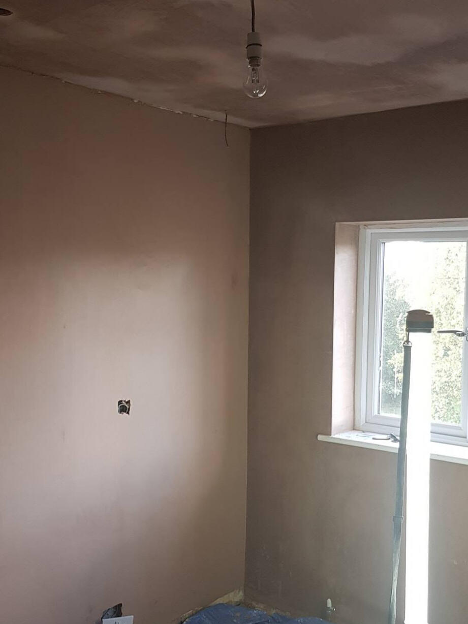 Smooth skim finish on bedroom walls and ceiling